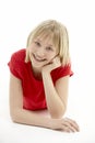 Young Girl Lying On Stomach In Studio Royalty Free Stock Photo