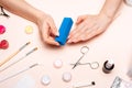 A young girl makes a manicure at home. Modern way of life.