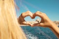 A young girl making heart with hands in rings,symbol of love from the boat at beautiful view on Valletta ,Malta Royalty Free Stock Photo