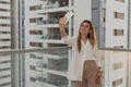 Young girl making selfie using mobile phone in a balcony a sunny day. Royalty Free Stock Photo