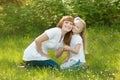 A young girl with mather on a green grass