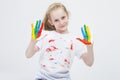 Young Girl With Messy Colorful Palms While Making Handprints On T-Shirt With Fresh Paint.