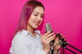 Young girl with microphone in studio.