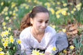 Young girl in the middle of daffodils Royalty Free Stock Photo