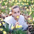 Young girl in the middle of daffodils Royalty Free Stock Photo