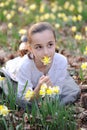 Young girl in the middle of daffodils Royalty Free Stock Photo