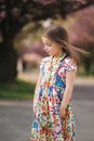 Young girl model poses to photographer. Female kid i beautiful dress outside. End of quarantine
