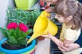 Young girl and mother watering potted flower plant smiling Royalty Free Stock Photo
