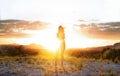 Young girl with at mountain top against sunset looking at camera in Murcia, Spain. Walking and enjoying freedom in countryside. Royalty Free Stock Photo