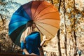 Young girl with multicoloured umbrella