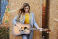 young girl musician playing acoustic guitar