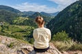 Young girl in the nature. Back view portrait of a single woman watching the Spajici lake from the height in west Serbia Royalty Free Stock Photo