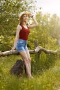 Young girl on nature with hat and backpack. Summer Royalty Free Stock Photo