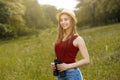 Young girl on nature with hat and binocular. Summer Royalty Free Stock Photo