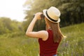Young girl on nature with hat and binocular. Summer Royalty Free Stock Photo