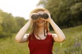 Young girl on nature with hat and binocular. Summer Royalty Free Stock Photo