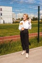 Young girl near school fence, say hi Royalty Free Stock Photo