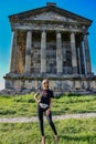 A young girl near the temple of Garni pagan, a Greek temple in the Republic of Armenia. May 3, 2019. Royalty Free Stock Photo