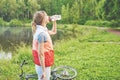 Young girl next to her bike drinking water while having a break Royalty Free Stock Photo