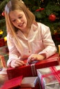 Young Girl Opening Christmas Present