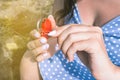 Young girl opens the lock with a key. Red lock in the form of a heart. The concept of dating, relationship and love. Royalty Free Stock Photo