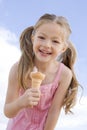Young girl outdoors eating ice cream cone
