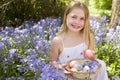 Young girl outdoors holding various eggs in basket Royalty Free Stock Photo