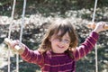 Young girl outside in backyard having fun on a swing Royalty Free Stock Photo