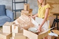 Young girl packing plates into the boxes ready to move. Woman unpacking moving boxes in her new home. unpack personal Royalty Free Stock Photo