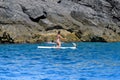 Young girl paddleboarding in a calm ocean