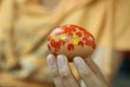 Young girl painting Easter eggs in hand.  April spring season and Easter holiday creative activity. Royalty Free Stock Photo