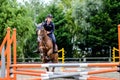 Young girl participating in a show jumping competition with her mare Royalty Free Stock Photo