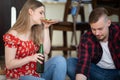 A young girl at a party eats pizza and drinks beer. Royalty Free Stock Photo