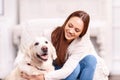 Young girl patting her pet dog