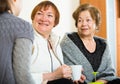 Young girl paying visit to senior grandmothers Royalty Free Stock Photo