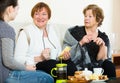 Young girl paying visit to senior grandmothers Royalty Free Stock Photo