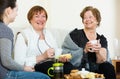 Young girl paying visit to senior grandmothers Royalty Free Stock Photo