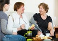 Young girl paying visit to senior grandmothers Royalty Free Stock Photo