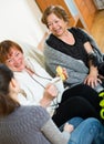 Young girl paying visit to senior grandmothers Royalty Free Stock Photo