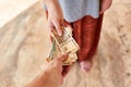 A young girl pays Indian rupees. The girl pays the man. Royalty Free Stock Photo