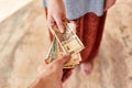 A young girl pays Indian rupees. The girl pays the man. Royalty Free Stock Photo