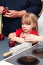 Young girl peeling apples in kitchen