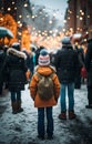 Young girl and people enjoying of a traditional illumination Christmas Market and a charming winter holidays