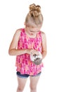 A young girl petting the stomach of her pet hedgehog