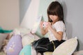 Young girl photographer make photo of her toy camera. Cute little girl play at home Royalty Free Stock Photo