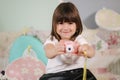 Young girl photographer make photo of her toy camera. Cute little girl play at home