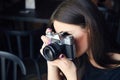 Young girl photographer with old analog camera in cafe Royalty Free Stock Photo