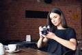 Young girl photographer with old analog camera in cafe Royalty Free Stock Photo