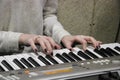 A young girl pianist plays the electronic piano with her favorite music. Female graceful hands touch the keys of the synthesizer c Royalty Free Stock Photo