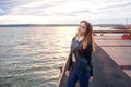 Young girl on the pier stands smiling Royalty Free Stock Photo